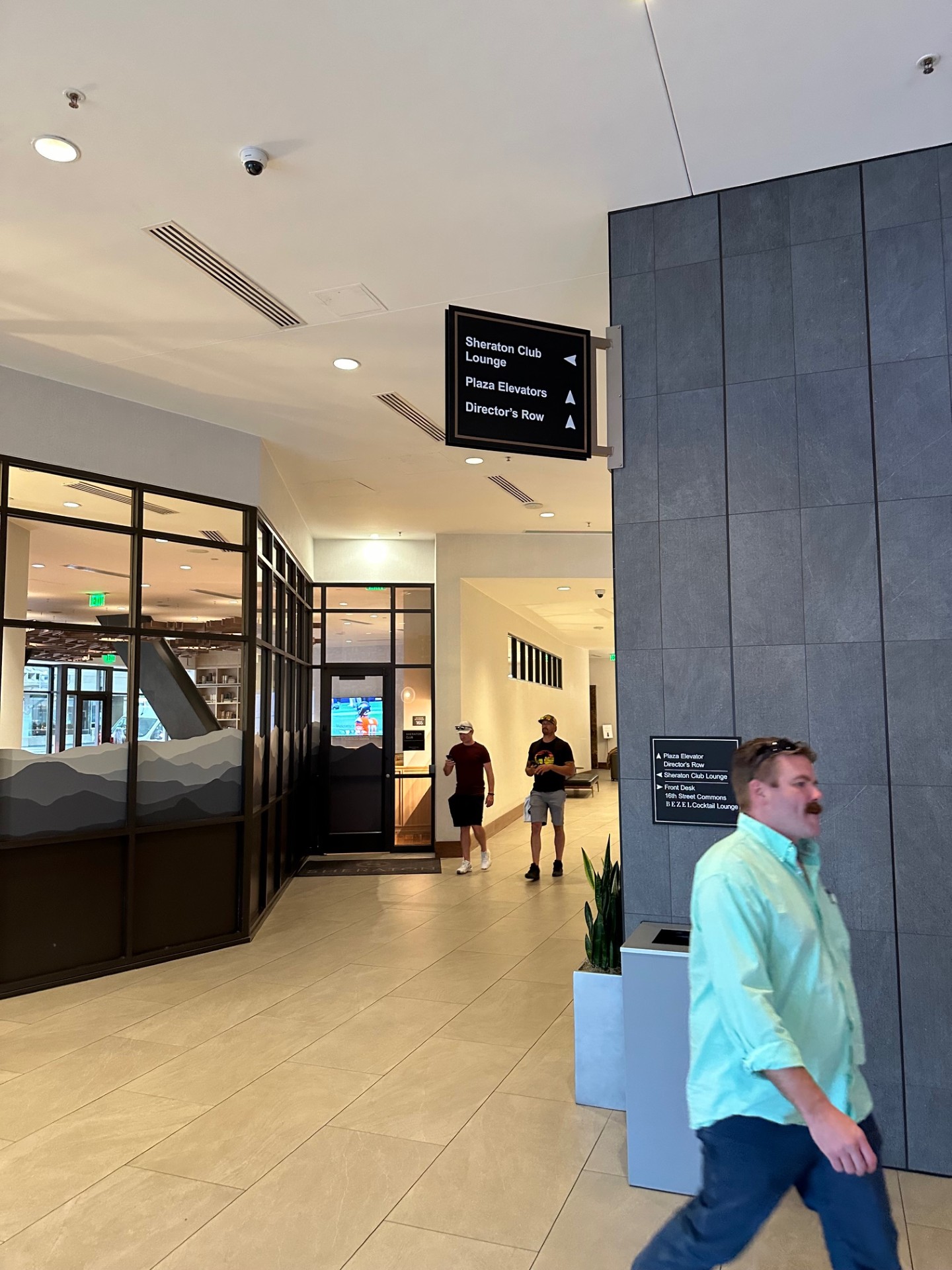 Hotel lobby area showing directional signage for Plaza Elevators and Director's Row